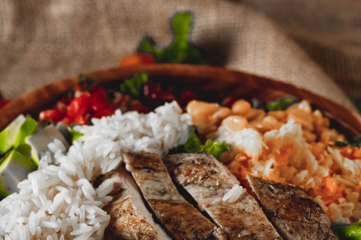 Grilled chicken breast with rice and salad, a staple high protein muscle building diet plate