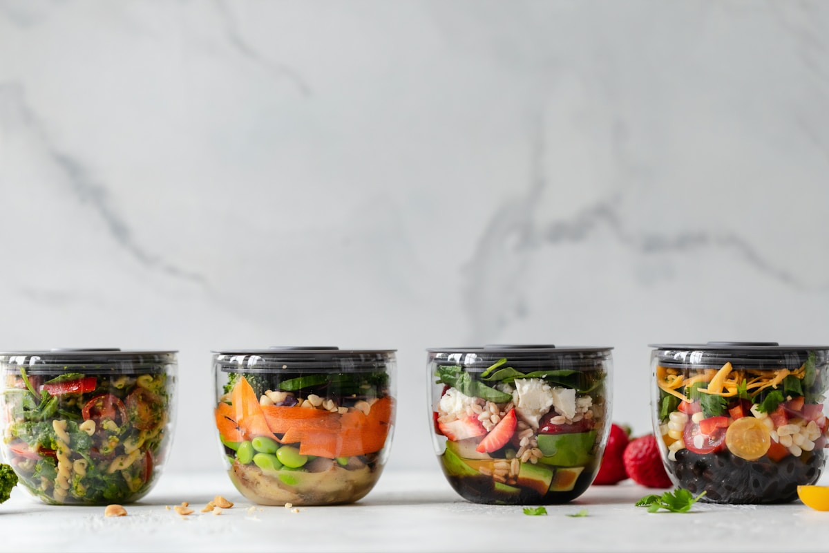 Meal prep containers with portioned protein and vegetables for muscle gain