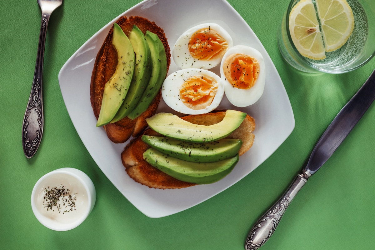 Plate with boiled eggs and avocado, a typical egg diet meal