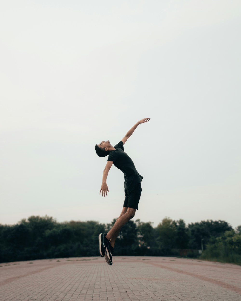 Man performing an explosive jump during a HIIT workout at home