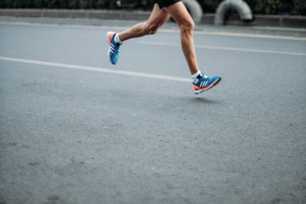 Pair of running shoes on the grass, the choice between walking or running for weight loss