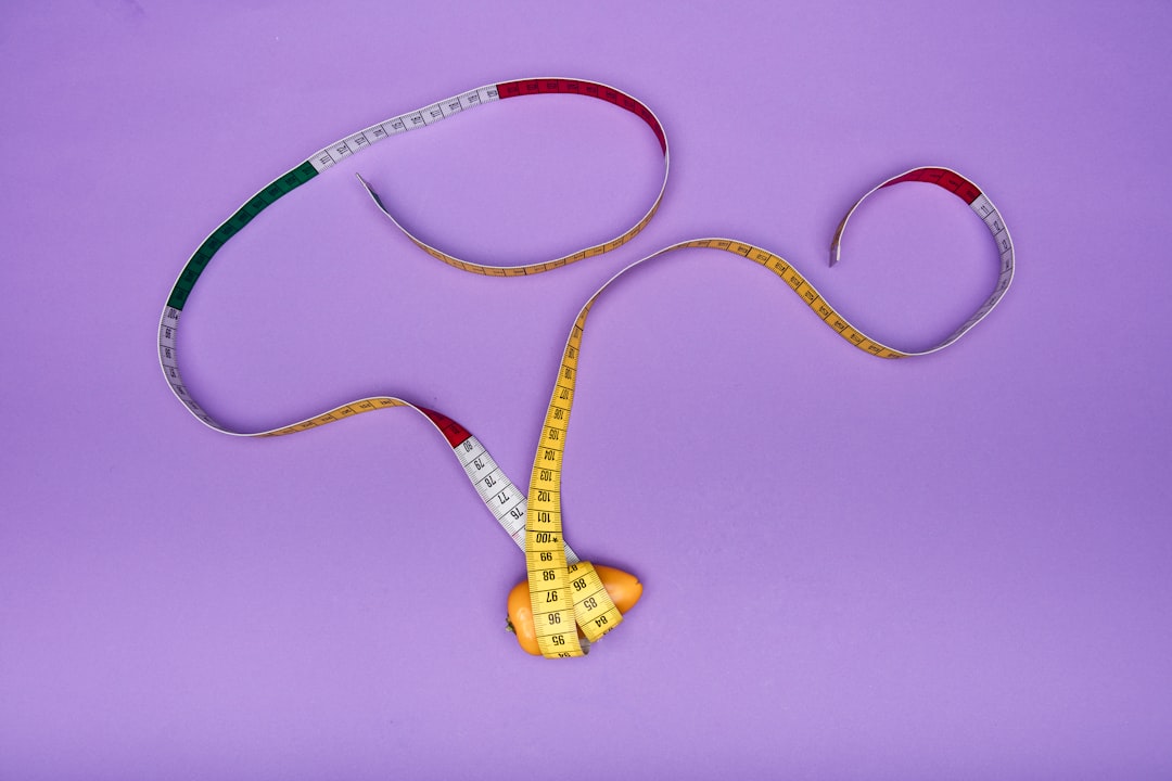 Hands holding a measuring tape, representing the body data used to calculate basal metabolic rate
