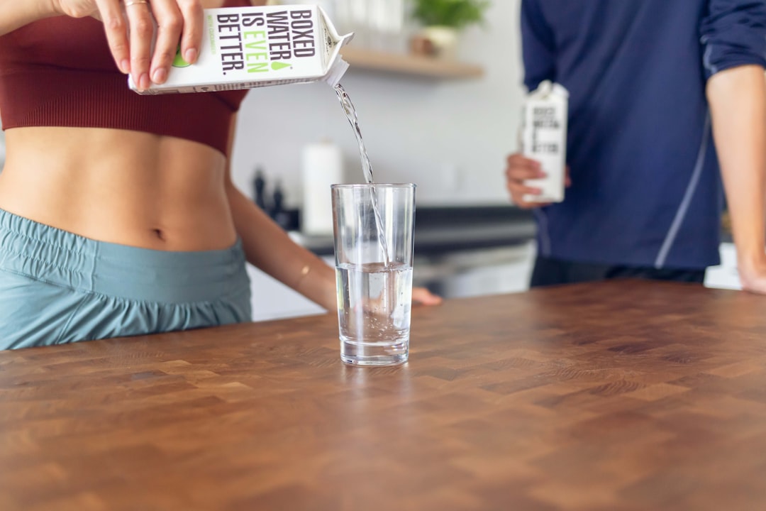 Woman sitting at a table, representing consistent tracking of weight and eating routine