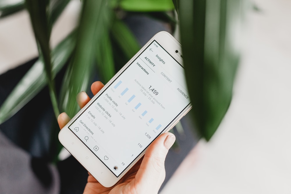 Person holding a smartphone with a calorie tracking app