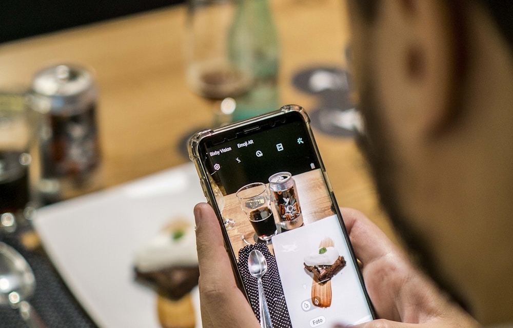 Person logging the meal in a diet app using the phone camera