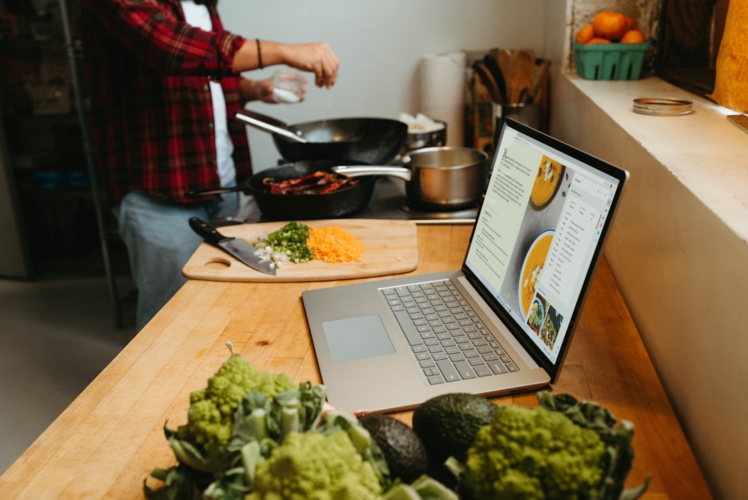 Laptop on a wooden table set up for an online dietitian appointment