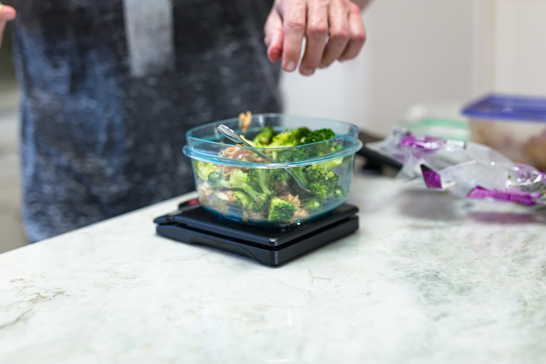 Weighing food on a kitchen scale to count calories accurately
